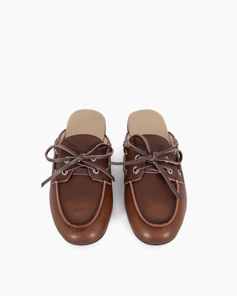 Pair of brown leather shoes with laces on a white background
