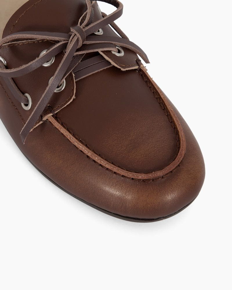 Brown leather shoe with laces on a white background